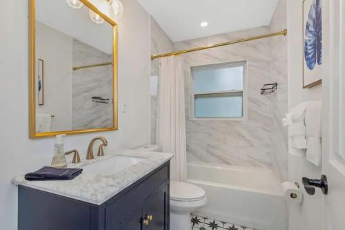 a bathroom with a sink and a tub and a toilet at Hidden Gem 3 Bedroom Home in Largo