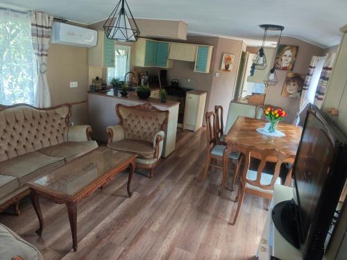 a living room with a couch and a table at Agroturystyka u Kozdryka in Leśna