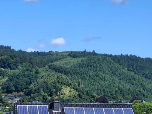 a group of solar panels in front of a mountain at Les mésanges bleu in Malmedy