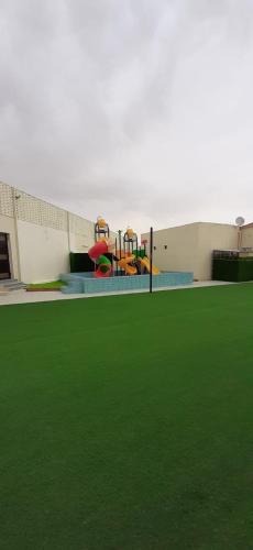 a playground in a building with green grass at استراحة الدرة in Taif