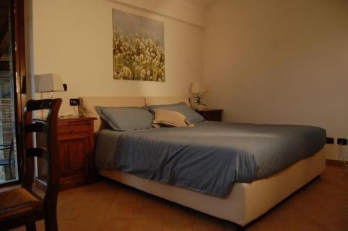 a bedroom with a bed and a dresser and a painting at Agriturismo Lapone in Orvieto