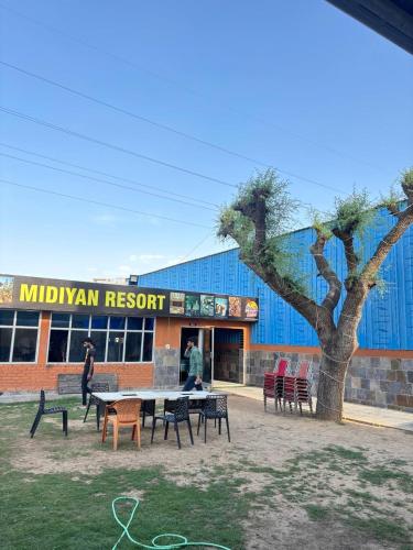 a group of tables and chairs in front of a building at Midiyan Resort in Jaipur