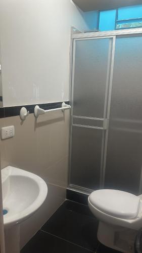 a bathroom with a shower and a toilet and a sink at Casas Hogar Andina Huancayo in Huancayo