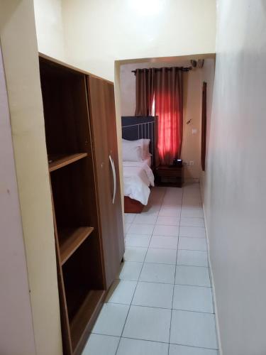 a room with a bedroom with a bed and a window at Romeo Suites & Apartment in Ipaja
