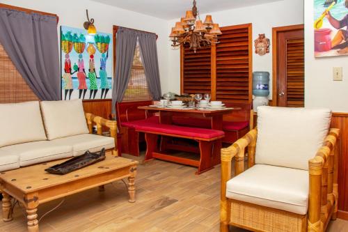 a living room with a table and chairs and a dining room at Villas De Isla Bonita in San Pedro