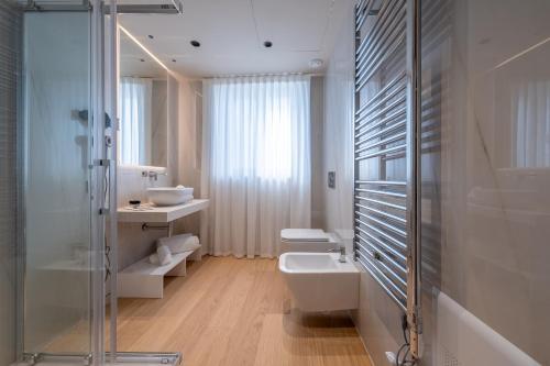 a bathroom with a shower and a toilet and a sink at Oriana Homèl Milano in Milan