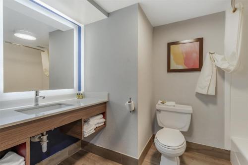 a bathroom with a white toilet and a sink at Best Western Plus Lexington Inn in Lexington