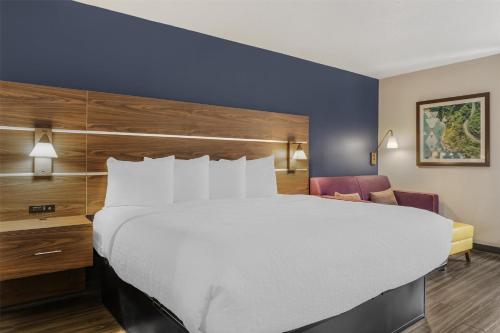 a hotel room with a large bed and a desk at Best Western Plus Lexington Inn in Lexington