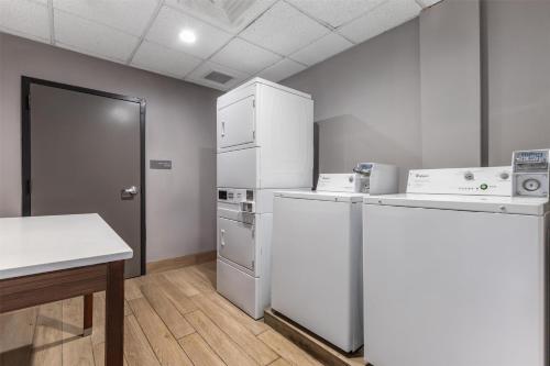 a kitchen with white appliances and a refrigerator at Best Western Plus Lexington Inn in Lexington