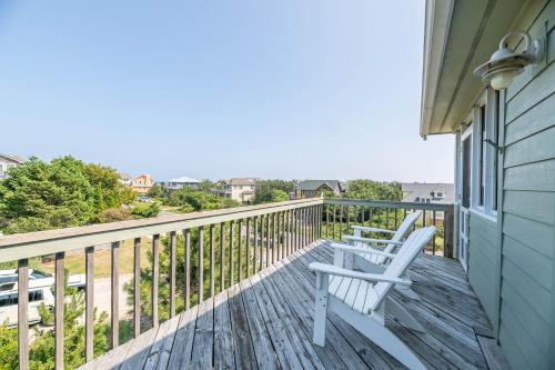 two white chairs sitting on a deck with a view at De-Duck-Tible - D0318 in Duck