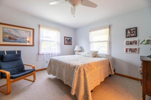 a bedroom with a bed and a blue chair at De-Duck-Tible - D0318 in Duck