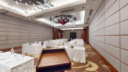 a banquet hall with white tables and chairs at Radisson Blu Hotel, Nagpur in Nagpur