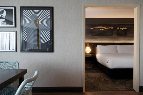 a hotel room with a bed and a table and a table sidx sidx at Renaissance Chicago North Shore Hotel in Northbrook