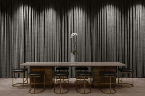 a table with chairs and a vase with flowers at Renaissance Chicago North Shore Hotel in Northbrook