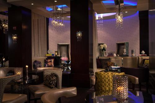 a restaurant with chairs and tables and chandeliers at Renaissance Chicago North Shore Hotel in Northbrook