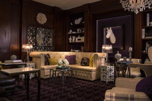 a living room with a couch and a table at Renaissance Chicago North Shore Hotel in Northbrook