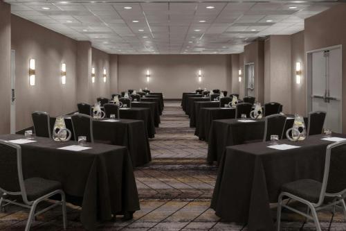 a row of tables in a room with black table cloths at Renaissance Chicago North Shore Hotel in Northbrook