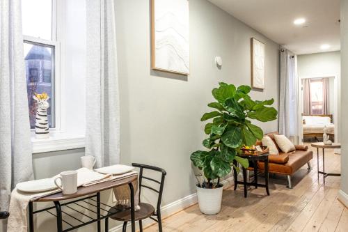 a living room with a table and a plant at The Castle in Washington, D.C.