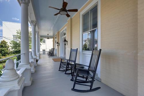 a porch with chairs and a ceiling fan at The 200 South St - King Ste 9 in Charlottesville