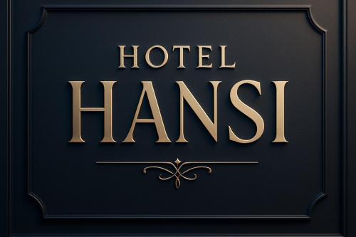 a gold sign that reads hotel harish on a black background at Hotel Hansi in Hānsi