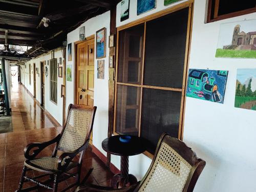 a room with two chairs and a table and a window at Casa de Los Berrios in León