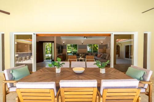 a dining room with a wooden table and chairs at Total Privacy, Prime Location, Design in Sosúa