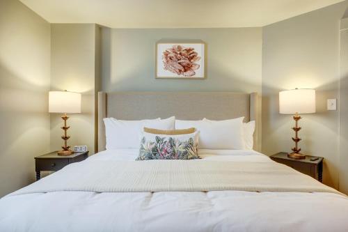 a bedroom with a large white bed with two lamps at The 200 South St - King Rm 14 in Charlottesville