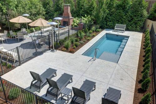 an overhead view of a swimming pool with four chairs at The 200 South St - King Rm 3 in Charlottesville
