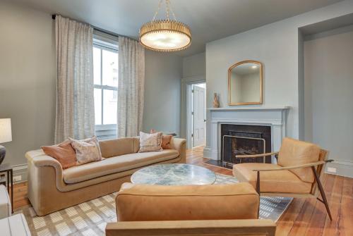 a living room with a couch and a fireplace at The 200 South St - King Rm 3 in Charlottesville
