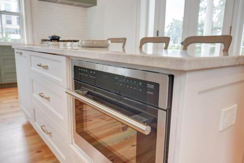 a kitchen with a counter with an oven at The 200 South St - King Rm 3 in Charlottesville