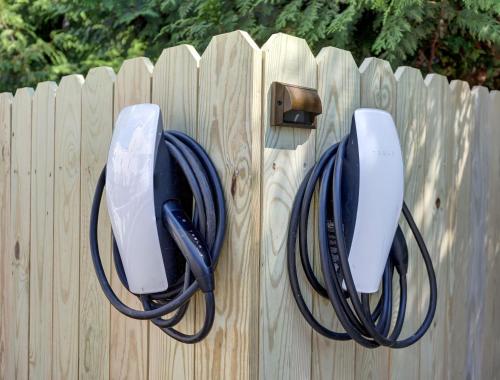 a wooden fence with a pair of chargers on it at The 200 South St - King Rm 3 in Charlottesville