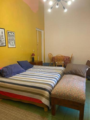 a bedroom with a large bed and a chair at Maska Mansion Expiatorio Gdl Guest house in Guadalajara