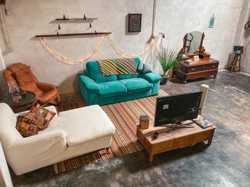 a living room with two couches and a tv at Montijo Garden - Studio with garden view in Montijo