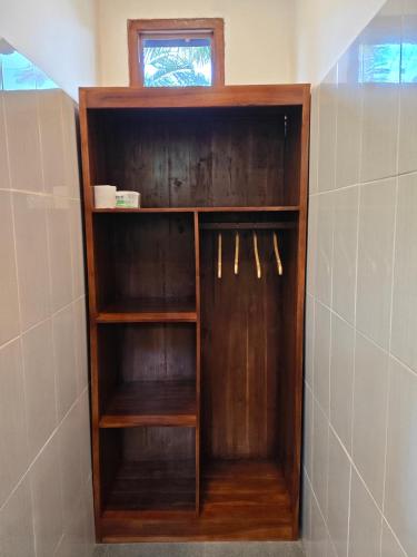 a wooden book shelf in a bathroom at Olimpus ecolodge in Tabanan