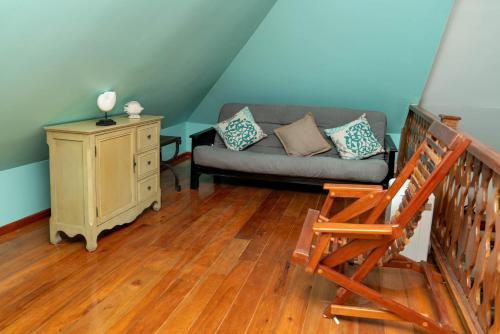 a living room with a couch and a chair at Villas De Isla Bonita in San Pedro