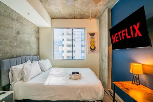 a small bedroom with a bed with a white bedspread at Charming 2BD - Central Downtown - Gym, Pool, Parking in Phoenix