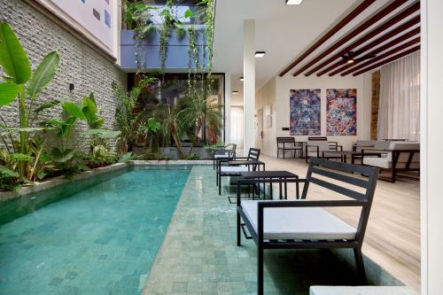 a restaurant with a swimming pool with tables and chairs at Casa Guogu by AmazINN Places 1f in Panama City