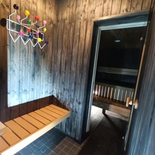 a bench in a room with a wooden wall at Aste loft apartement in Aste