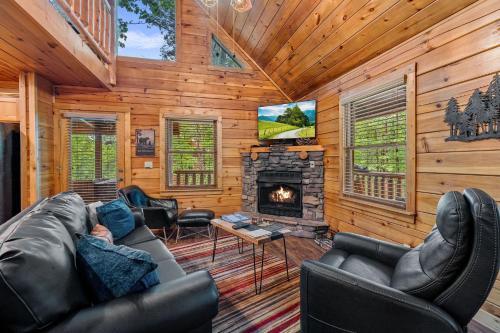 a living room with a fireplace in a log cabin at Moonlit Pines by American Patriot Getaways in Oldham