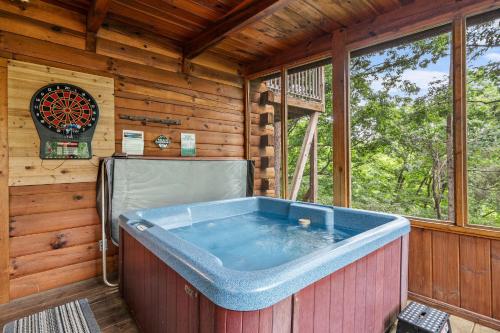 a jacuzzi tub in a log cabin at Moonlit Pines by American Patriot Getaways in Oldham