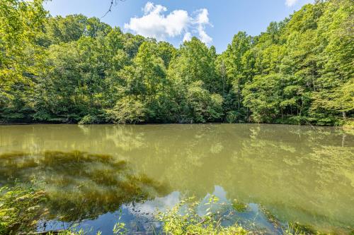 a body of water with trees in the background at Moonlit Pines by American Patriot Getaways in Oldham