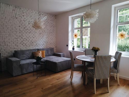 a living room with a couch and a table and chairs at Schupplerova vila in Hoštejn