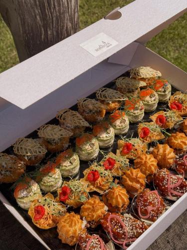 a tray of donuts sitting on top at Bonanza Terra in Rukliai