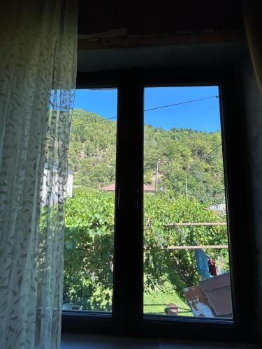 a window with a view of a mountain at Svaneti Heaven in Lentekhi