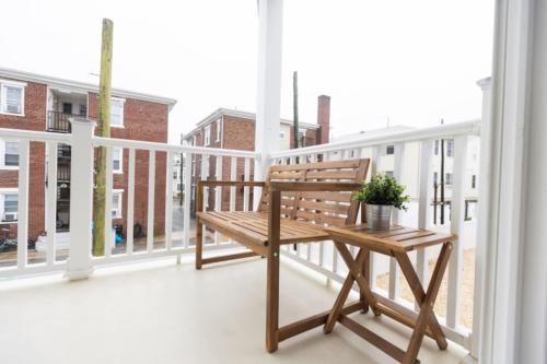 a wooden bench sitting on top of a balcony at Beautiful remodeled 3 bdr condo 200 ft from beach in Wildwood