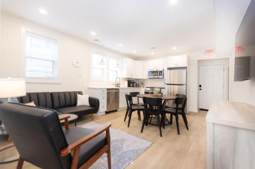 a living room with a couch and a table at Beautiful remodeled 3 bdr condo 200 ft from beach in Wildwood
