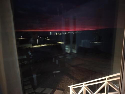 a view of the water at night from a window at Casa en la playa-campo in La Ligua
