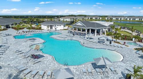 an aerial view of a pool at a resort at Stylish Golf Course Coach Home in Ave Maria in Harker