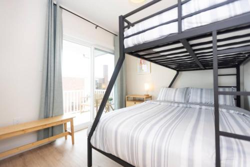 a bedroom with a bunk bed and a window at 500 ft to boardwalk, 3 bdr condo in Wildwood