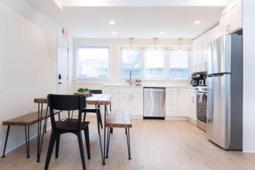 a kitchen with a table and chairs and a refrigerator at 3 BDR Renovated Condo The Beach1 block in Wildwood